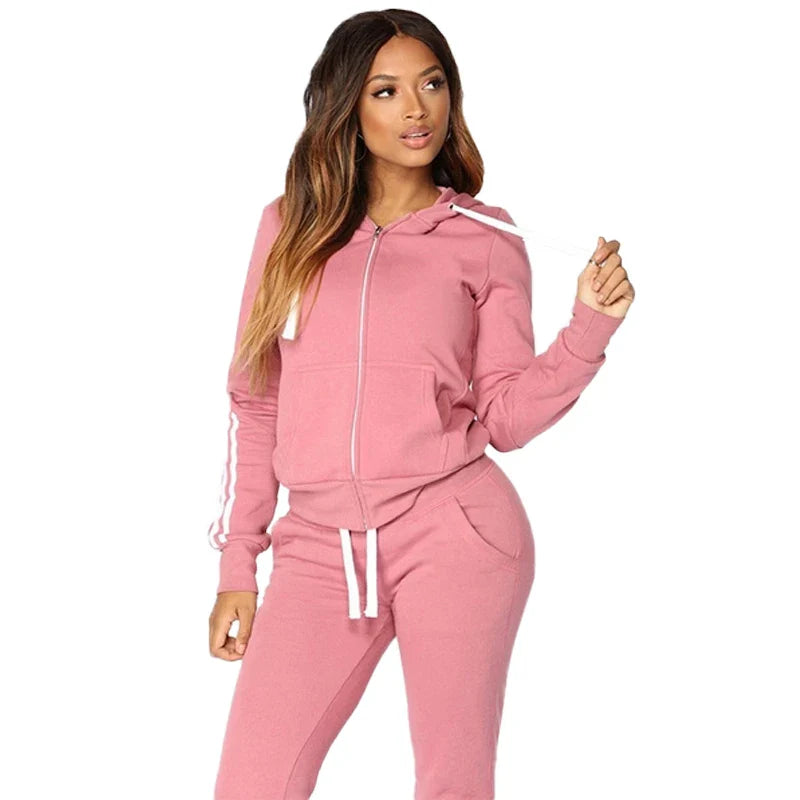 Trendy women's jogging tracksuit ensemble, characterised by zippers and soft fabric, perfect for leisurely spring outings or sporting activities.