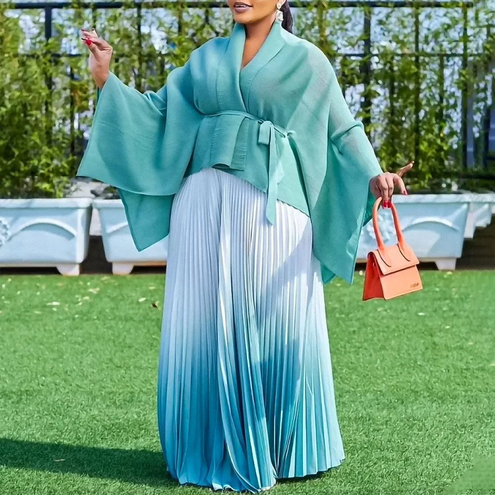 Detail shot of the long sleeve V-neck top from the Luxury Dashiki women's outfit, highlighting the exquisite stitching and vibrant colours, perfect for any festive occasion.