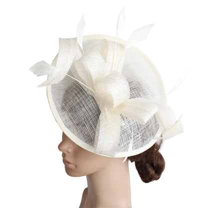 Close-up of luxurious sinamay fascinator hat in soft cream, showcasing fine craftsmanship ideal for Derby and party occasions.