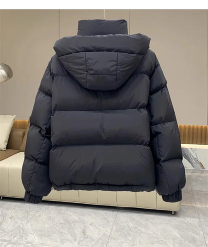 Refined women's padded parka jacket in a versatile design, tailored for comfort and elegance in chilly weather conditions.