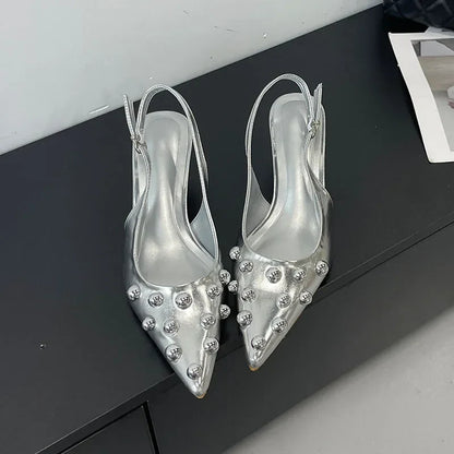 Trendy slip-on women's pumps with a pointed toe, elegant rivet detailing, suitable for both casual and upscale events.
