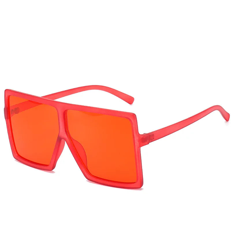 FenQiqi oversized square sunglasses on a chic surface, emphasizing their modern design and comfort for everyday wear.