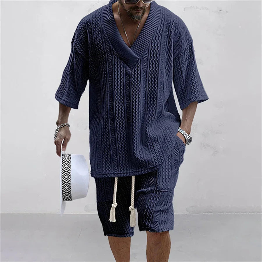 Exquisite detail of a men's knitted casual summer outfit set, featuring a solid coloured V-neck T-shirt and drawstring shorts, designed for effortless sophistication.