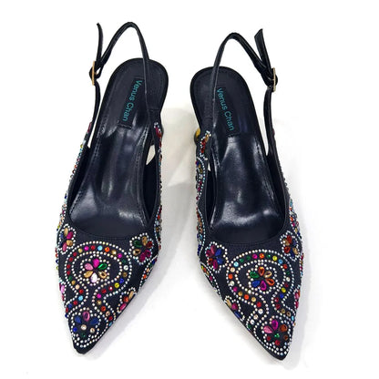 Chic fuchsia handbag featuring a metal handle and long chain shoulder strap, designed to coordinate beautifully with high heel pumps.