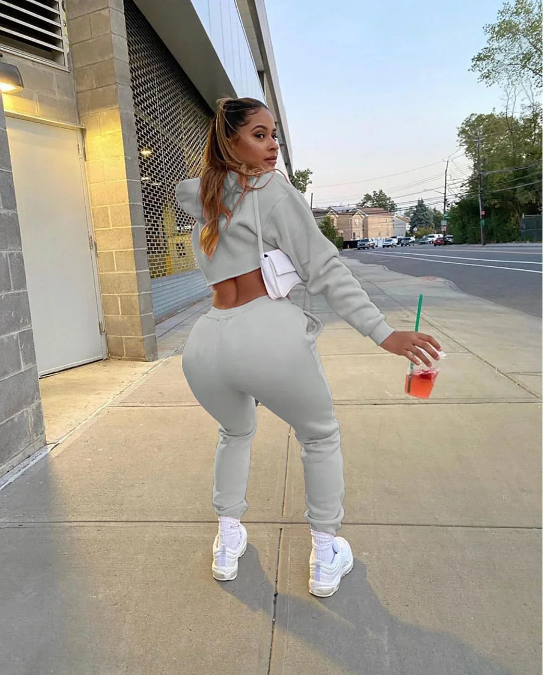 Luxury women’s pink fleece running set featuring a long sleeve cropped hoodie and jogger tracksuit, designed with a stylish spliced pattern.