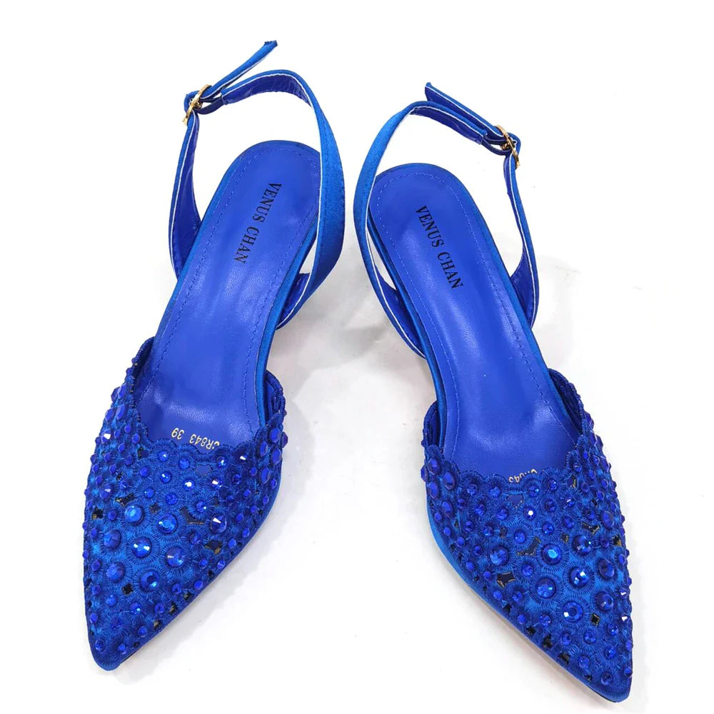 Elegant gold handbag that complements the Venus Chan high heel shoes, featuring a chic metal handle and sparkling rhinestone details.