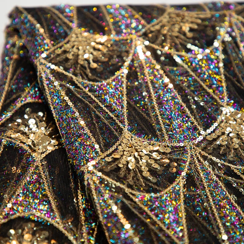 Detailed view of Kalume mesh lace fabric showcasing intricate sequin detailing, ideal for creating stunning evening wear.