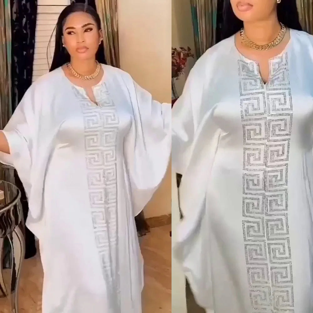 Elegant plus size African women in a bat sleeve V-neck maxi dress with diamond detail, epitomising luxury and Muslim style abaya.