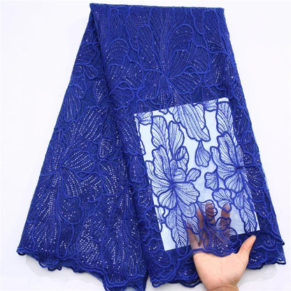 High-quality embroidered tulle featuring delicate lace patterns and shimmering sequins, perfect for Nigerian wedding gowns.