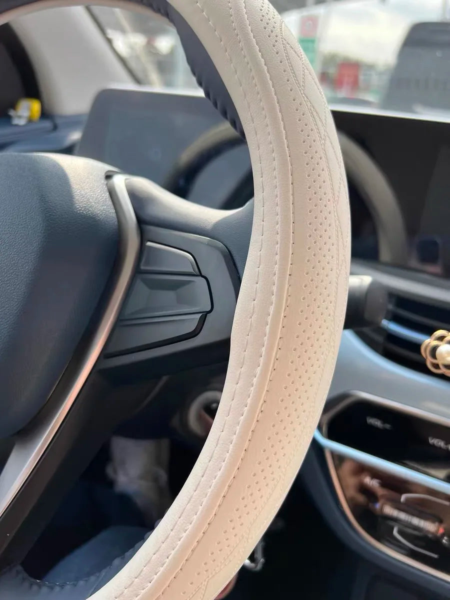 Close-up view of the universal 15-inch Napa Leather Steering Wheel Cover featuring breathable perforations and a non-slip grip for superior handling.