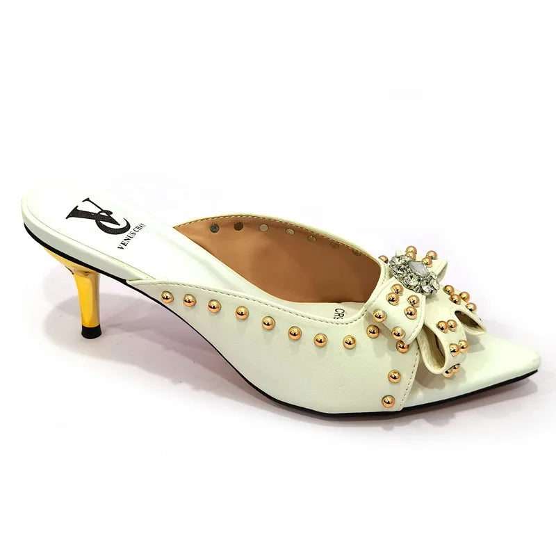 Close-up view of women's high heeled shoes with a pointed toe and super high thin heels, designed for glamour and comfort.