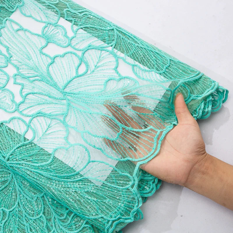 Beautifully crafted African lace fabric with sequins, highlighting eco-friendly features and luxurious texture for sophisticated attire.