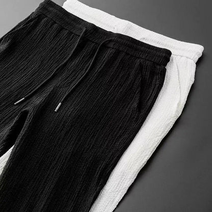 Men's summer casual suit in a refined style, consisting of an elastic waistband long pants and a short-sleeve shirt, crafted for effortless sophistication.