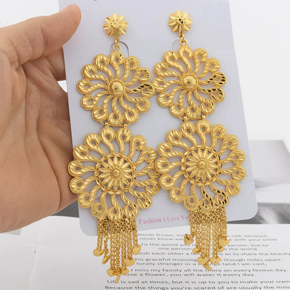 Luxury fashion drop earrings made from 18K gold plating, featuring a prominent copper tassel for a trendy and fashionable look.