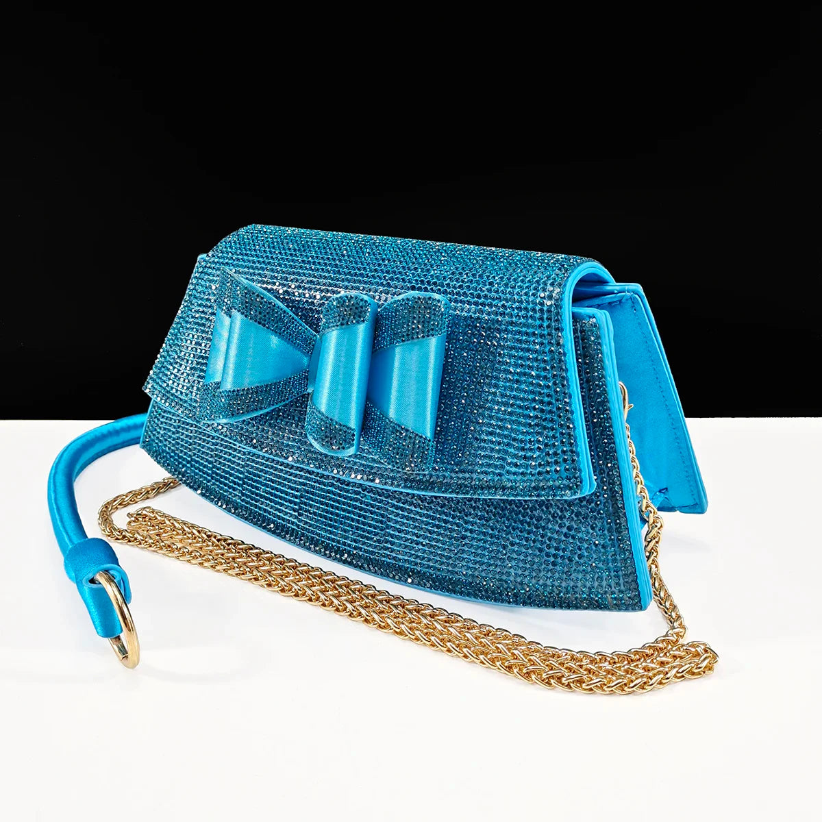 Chic coffee coloured women's handbag with a long chain strap, perfectly paired with stylish pointed toe shoes, embodying elegance and sophistication for special occasions.