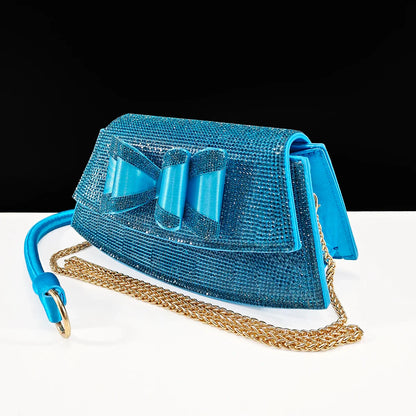 Chic coffee coloured women's handbag with a long chain strap, perfectly paired with stylish pointed toe shoes, embodying elegance and sophistication for special occasions.