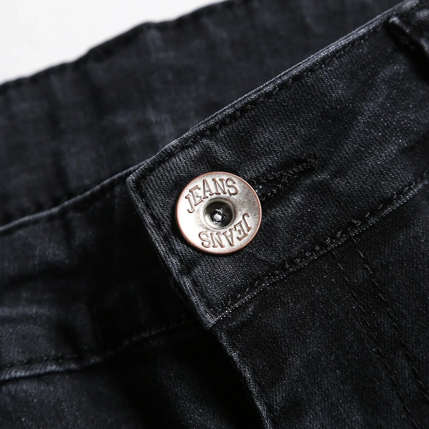 Close-up view of Luxury Men's Ripped Skinny Jeans, showcasing intricate stitching and fabric texture for an elevated fashion statement.