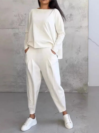 Elegant women's casual loose sports set featuring a sophisticated long sleeve irregular top paired with high waist harem pants, perfect for a chic autumn/winter look.