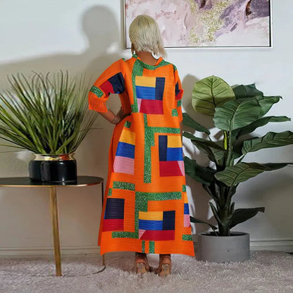 Luxurious African long dress with intricate pleating and 3/4 sleeves, perfect for celebrating cultural heritage.