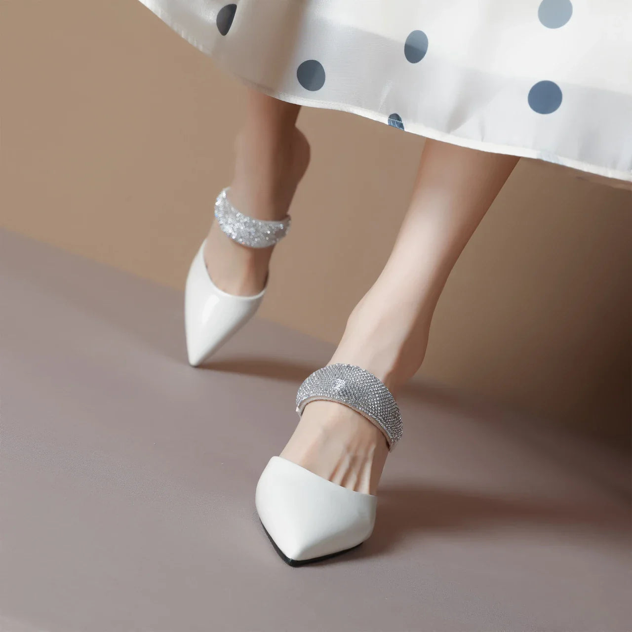 Close-up view of high heels slippers showcasing exquisite crystal embellishments, epitomising summer fashion for women.