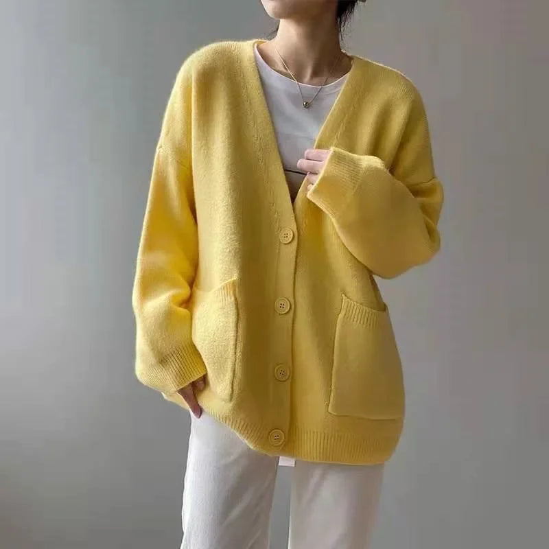 Sophisticated yellow cardigan for women, showcasing a soft knit texture and modern V-neck silhouette, ideal for layering in cooler seasons.