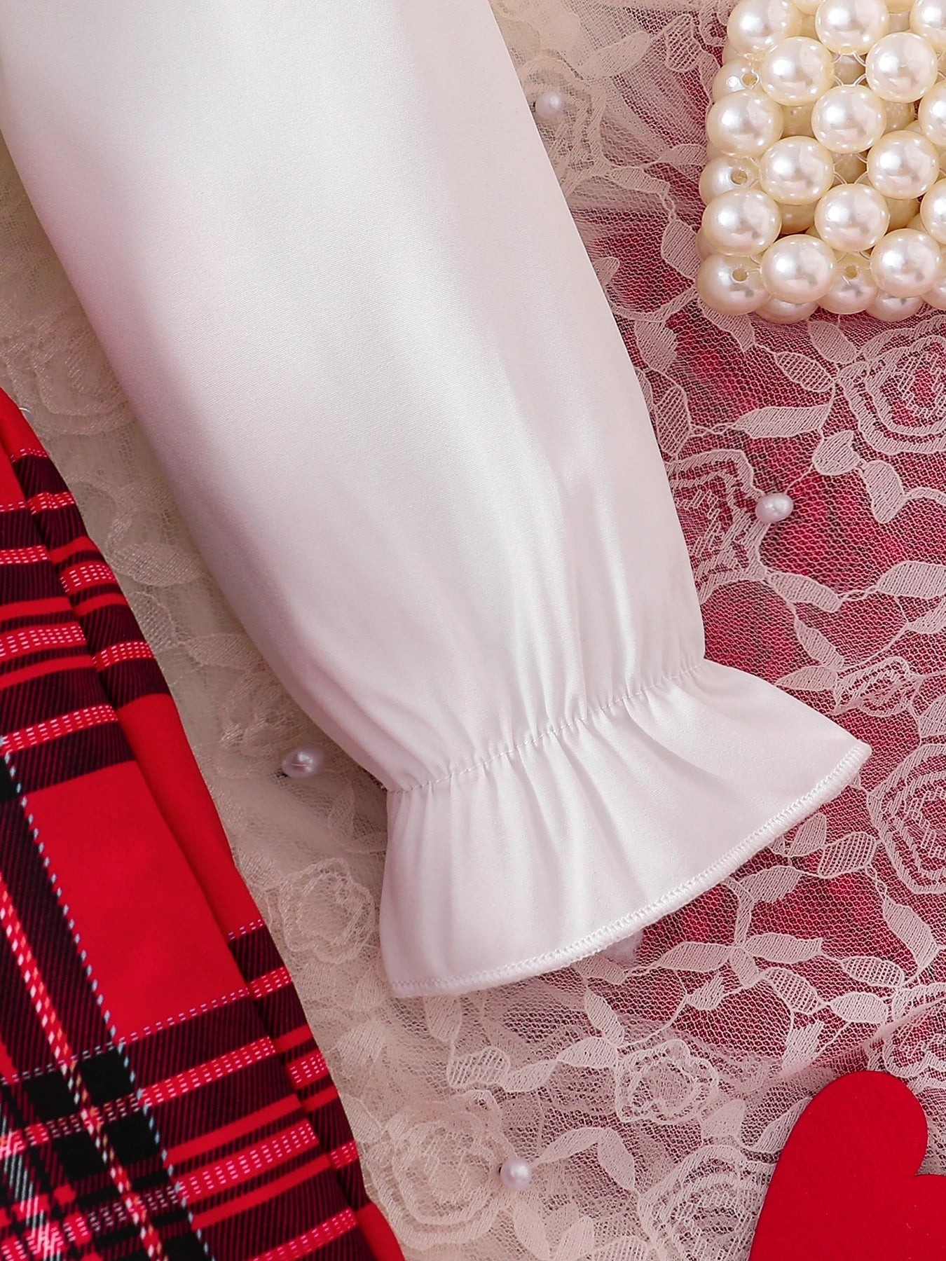 Stylish complete view of girls' fashionable knitted set, showcasing the vibrant red tank top and checkered skirt, perfect for ages 4-6.