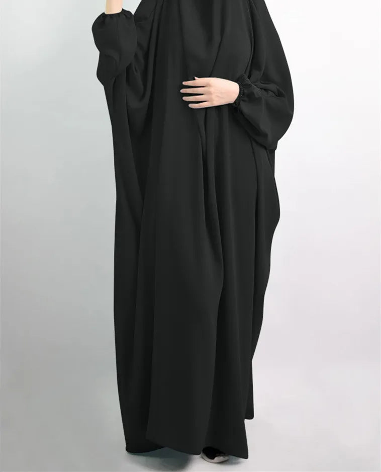 Elegant Muslim abaya dress for women crafted from casual polyester fabric with slight stretch, showcasing timeless sophistication and versatility for any occasion.