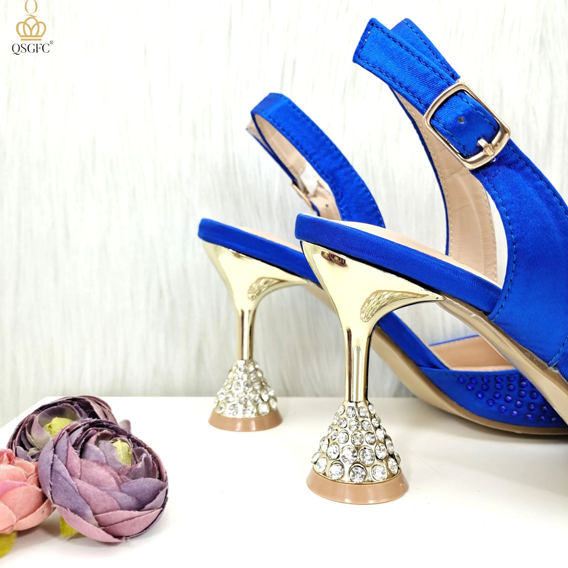 Close-up of stunning blue stiletto sandals showcasing intricate detailing with pearls and rhinestones, embodying luxury and style.