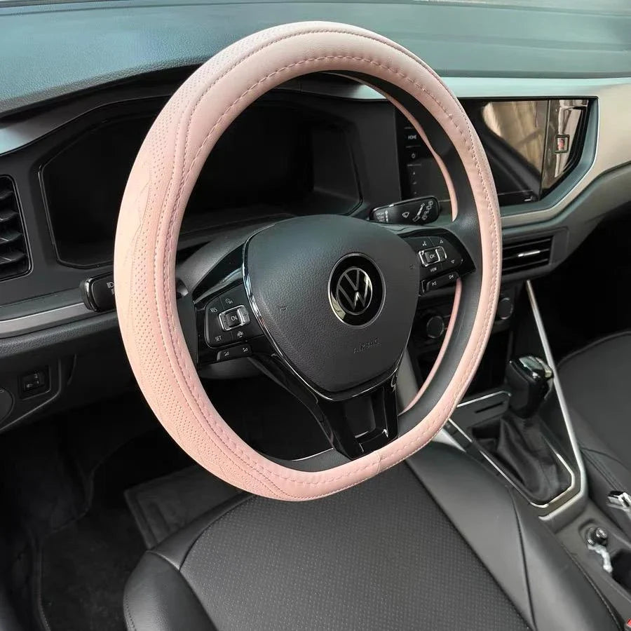 Sophisticated Napa Leather Perforated Patchwork Steering Wheel Cover displayed on a steering wheel, emphasizing its chic design and universal fit for all vehicles.