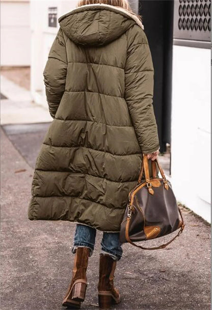 Elegant women's long sleeve winter jacket with a thick quilted texture, designed with functional pockets and a luxurious hood for added warmth and style.