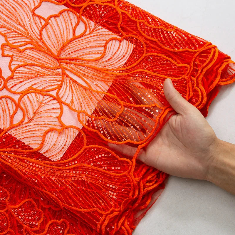 Exquisite lace fabric with a shimmering finish, perfect for formal bridal attire, showcasing artistry in embroidery for a luxurious wedding experience.