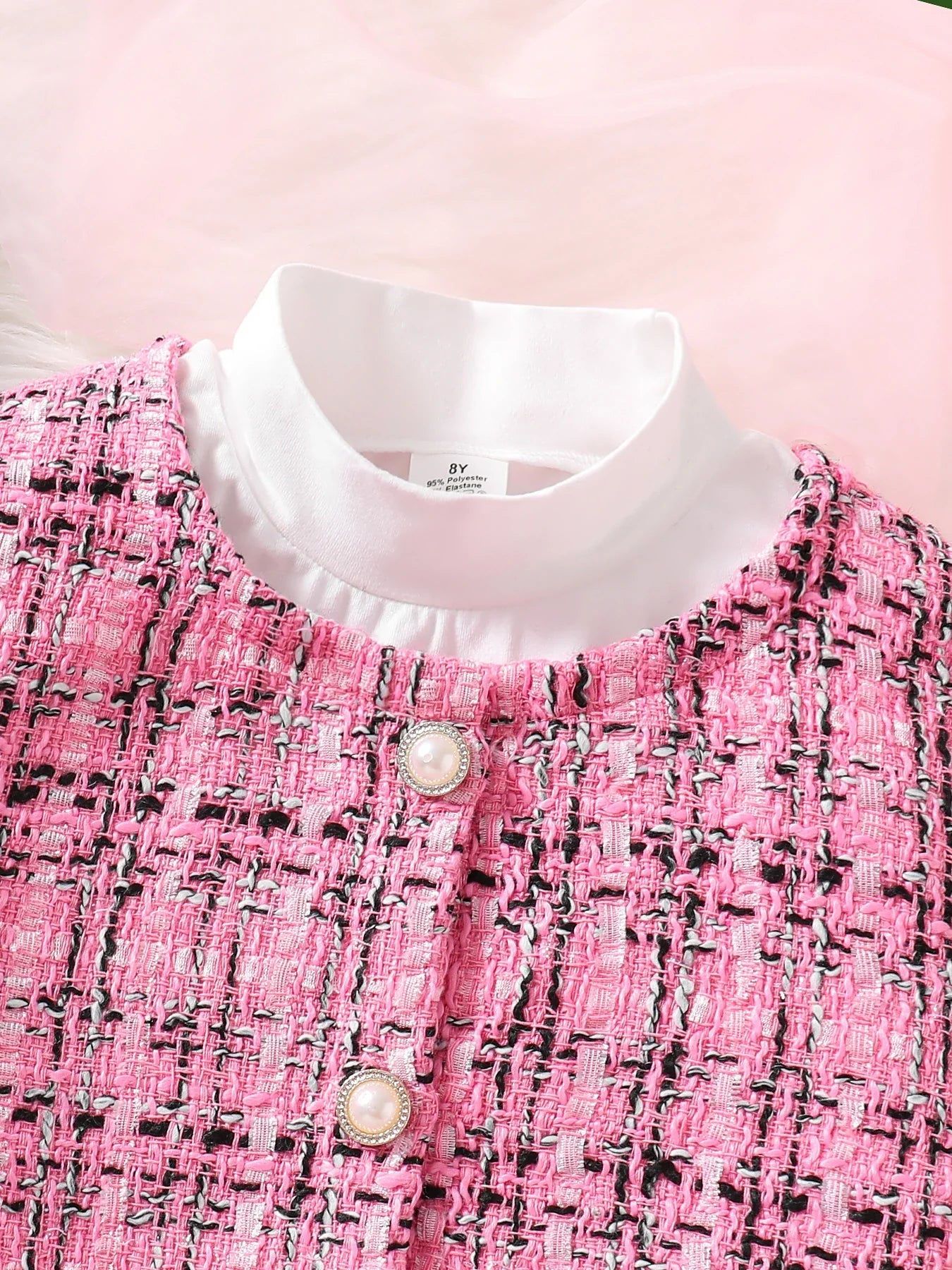 Elegant pink skirt from the luxury 3-piece fashion set for girls aged 7-13, complements the checkered coat beautifully.