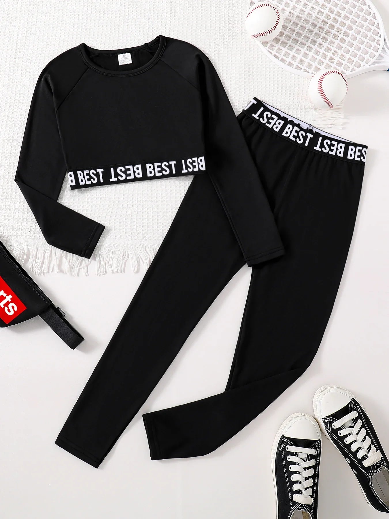 Chic girls' 2-piece fashion set featuring an elegant English print round neck long sleeve top and stylish slim fit black pants for ages 7-13, ideal for autumn with a thin polyester material.