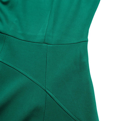 Close-up of the luxurious fabric and pleats of a knee-length evening dress made from soft polyester blend, ideal for stylish women.