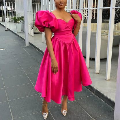 Model wearing the Deep Pink A-Line Midi Dress with Sweetheart Neckline and Puff Sleeves, exuding luxury and sophistication for an elegant evening.