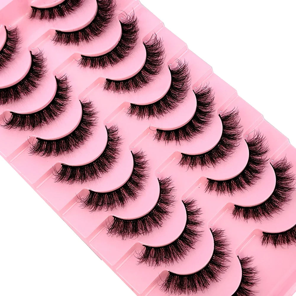 Close-up of a pair of fluffy faux mink lashes, highlighting their soft texture and dramatic length, perfect for enhancing eye makeup.
