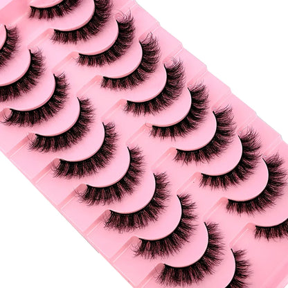 Close-up of a pair of fluffy faux mink lashes, highlighting their soft texture and dramatic length, perfect for enhancing eye makeup.