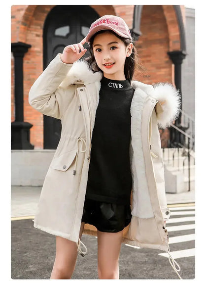 Stunning white velvet coat for girls, showcasing a fur-lined hood and stylish cut, ideal for fashionable winter outings.