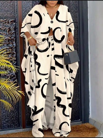 Elegant women's V-neck loose long-sleeved top, showcasing a striking letter print design, paired with wide leg pants, epitomizing casual luxury.