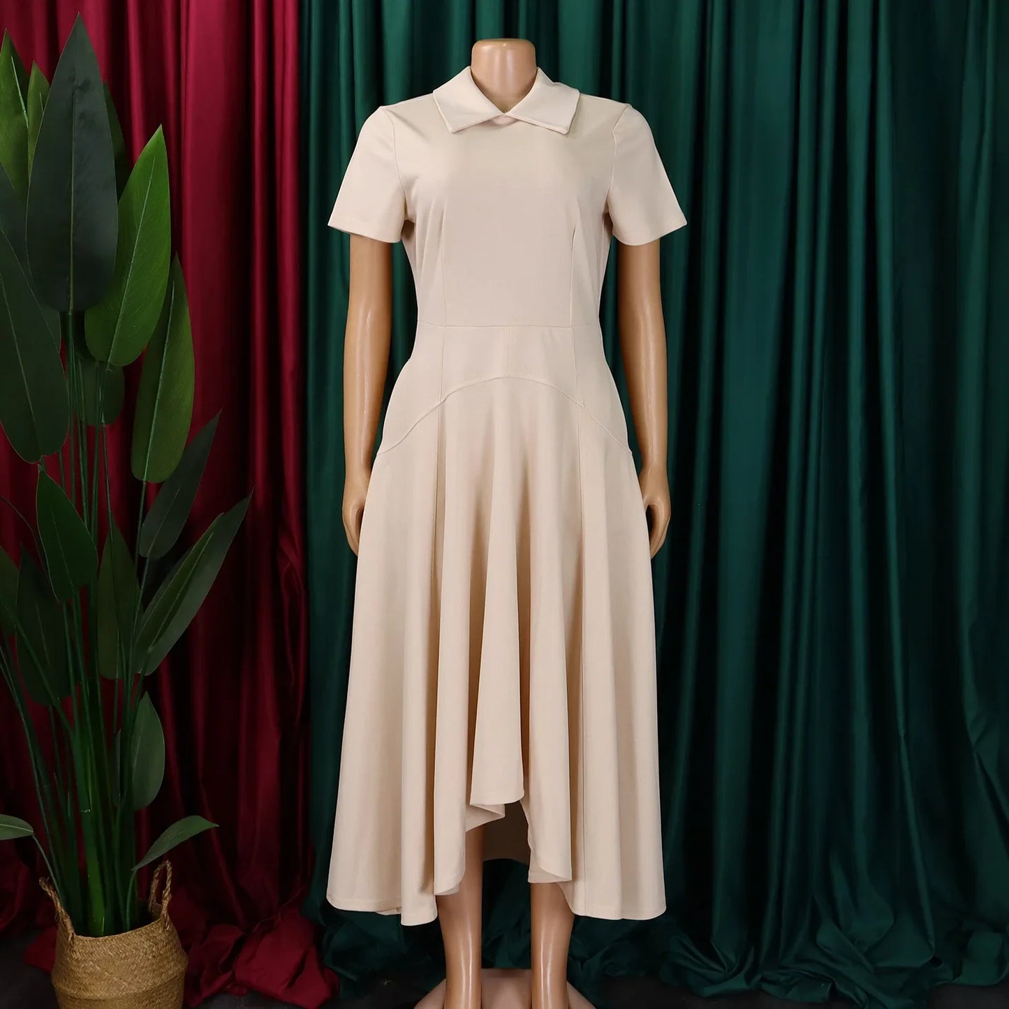 Stylish model wearing an elegant knee-length evening dress with Peter Pan collar, perfect for office and formal events.