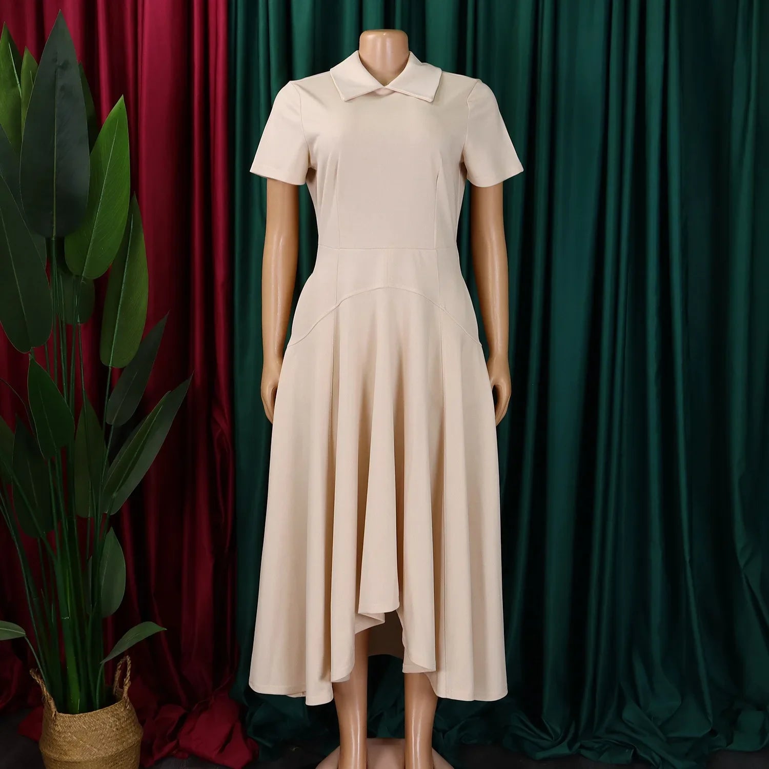 Stylish model wearing an elegant knee-length evening dress with Peter Pan collar, perfect for office and formal events.