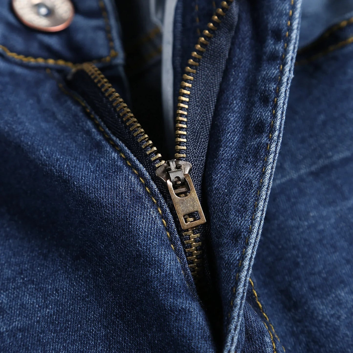 Close-up of luxury denim jeans for men, highlighting intricate design elements like fake zippers and a flattering skinny fit, perfect for stylish occasions.