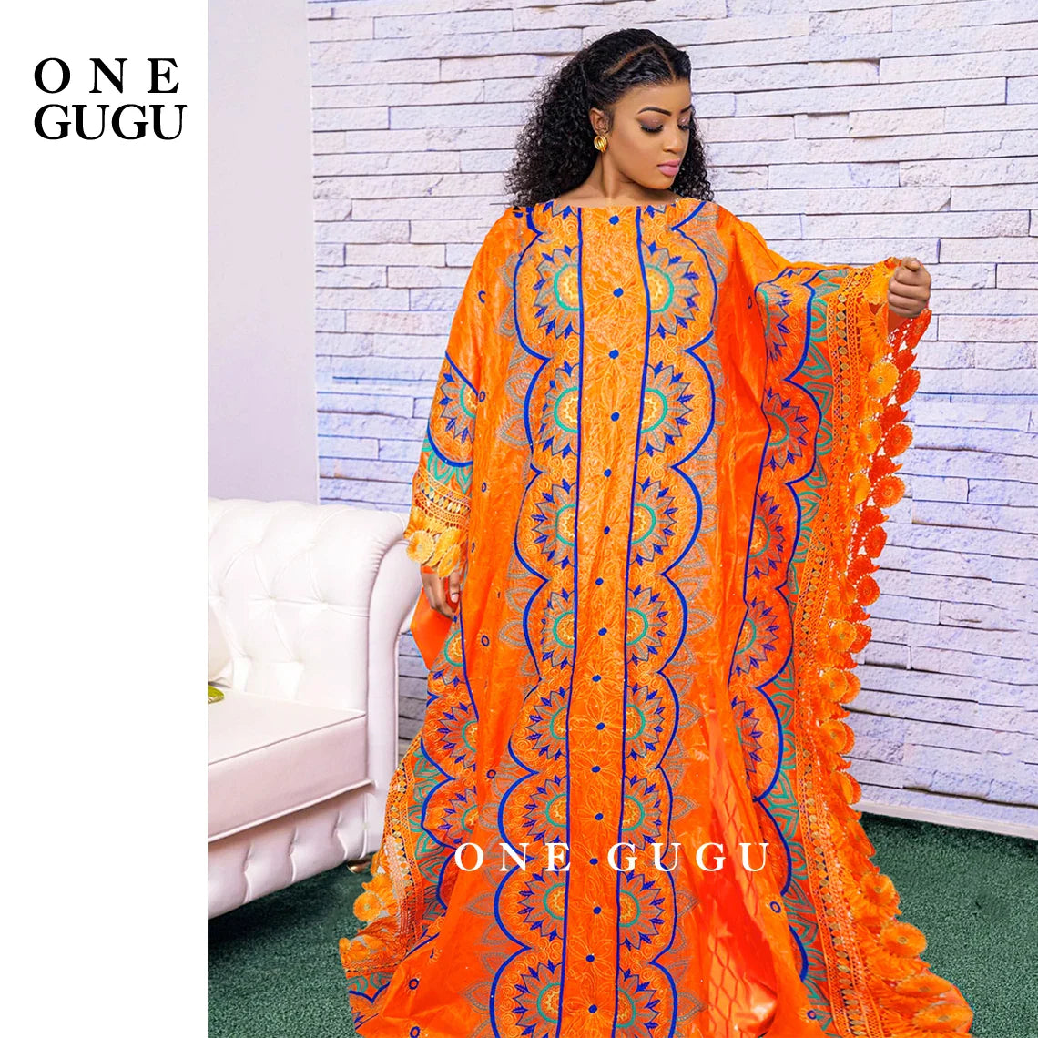 Luxurious orange Nigerian Bazin dress featuring intricate embroidery lace, ideal for elegant weddings and parties.