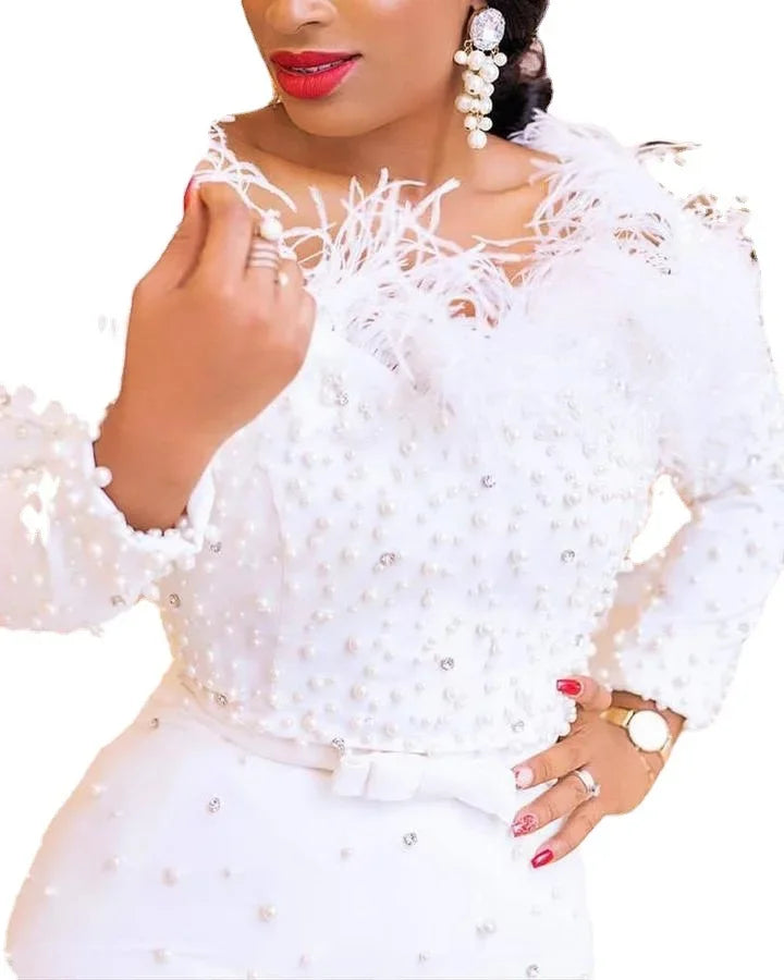 Dramatic flat lay of the elegant African white dress for women, emphasizing its luxurious polyester material and intricate design suitable for various occasions.