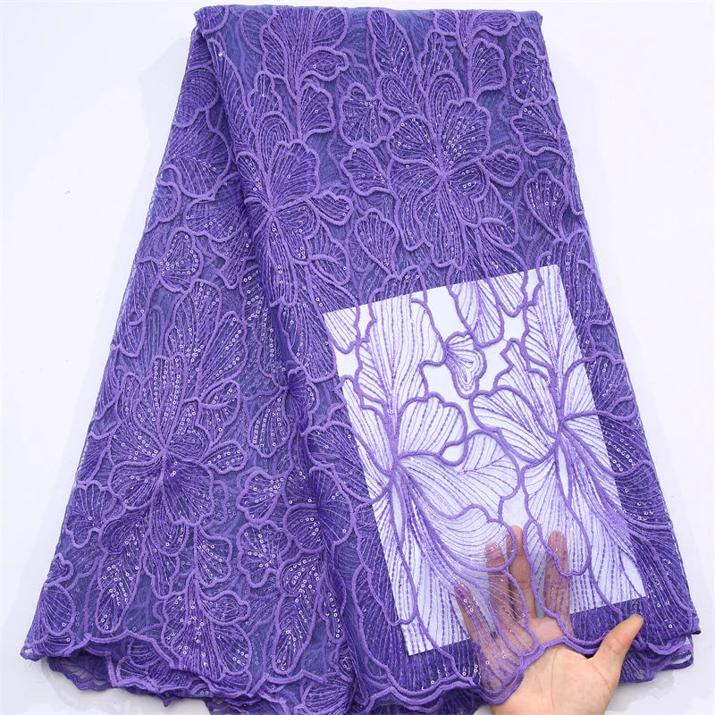 Close-up view of embroidered tulle lace fabric adorned with sequins, ideal for creating stunning wedding attire, showcasing intricate details and superior quality.