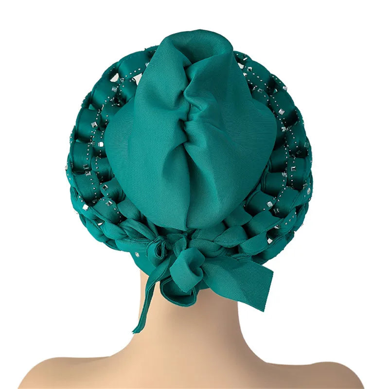 Close-up of the exquisite diamond decoration on a luxury African Autogele headtie turban, showcasing vibrant fabric and intricate design.