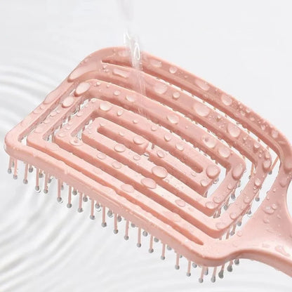 Stylish elastic hollow out massage comb placed against an upscale background, illustrating its sleek design suited for fashionable hair care.