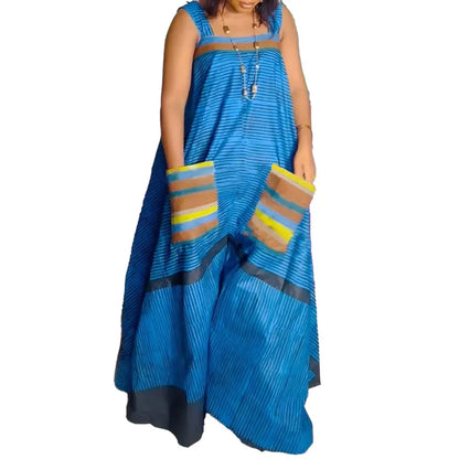 Elegant CM.YAYA Women’s Striped Wide Leg Sleeveless Jumpsuit with Pockets showcased in a chic summer setting, exuding luxury and style.