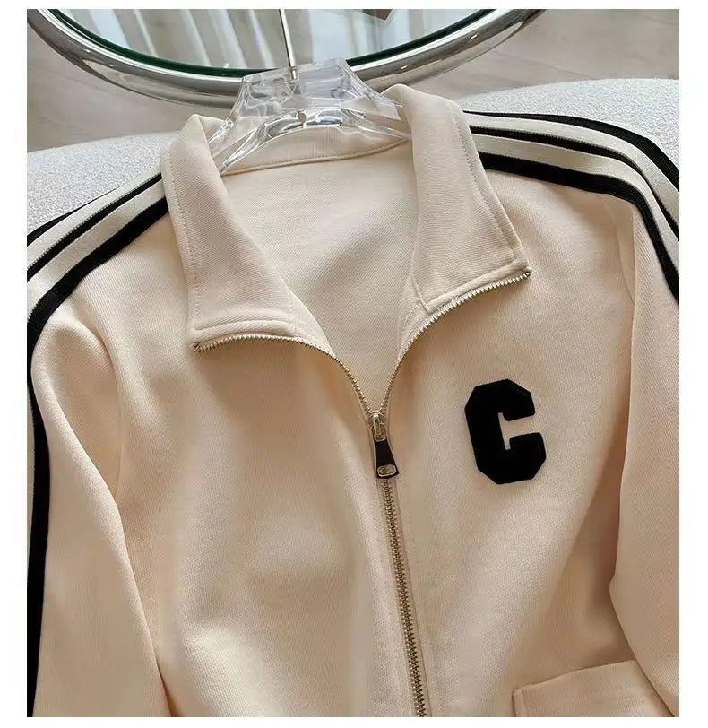 Model showcasing the complete high-end leisure sports set with embroidered coat and wide leg pants, embodying elegance for autumn winter fashion.