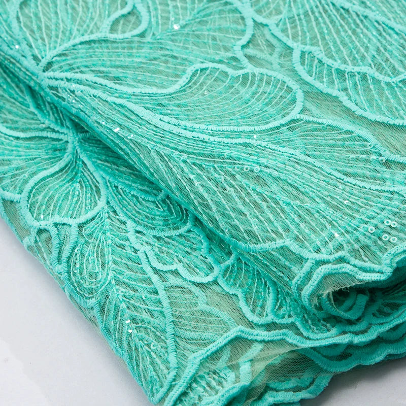 Elegant wedding dress fabric made of high-quality polyester and nylon, showcasing intricate embroidery and luxurious silk feel.